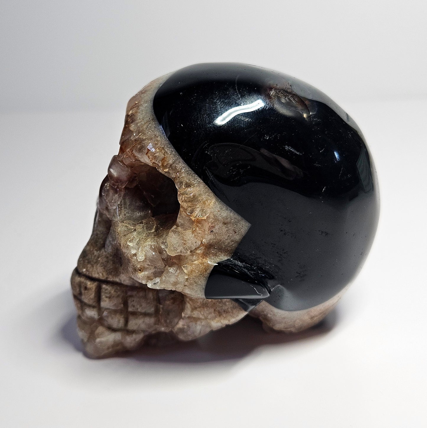 Druzy agate with amethyst and fire quartz skull carving