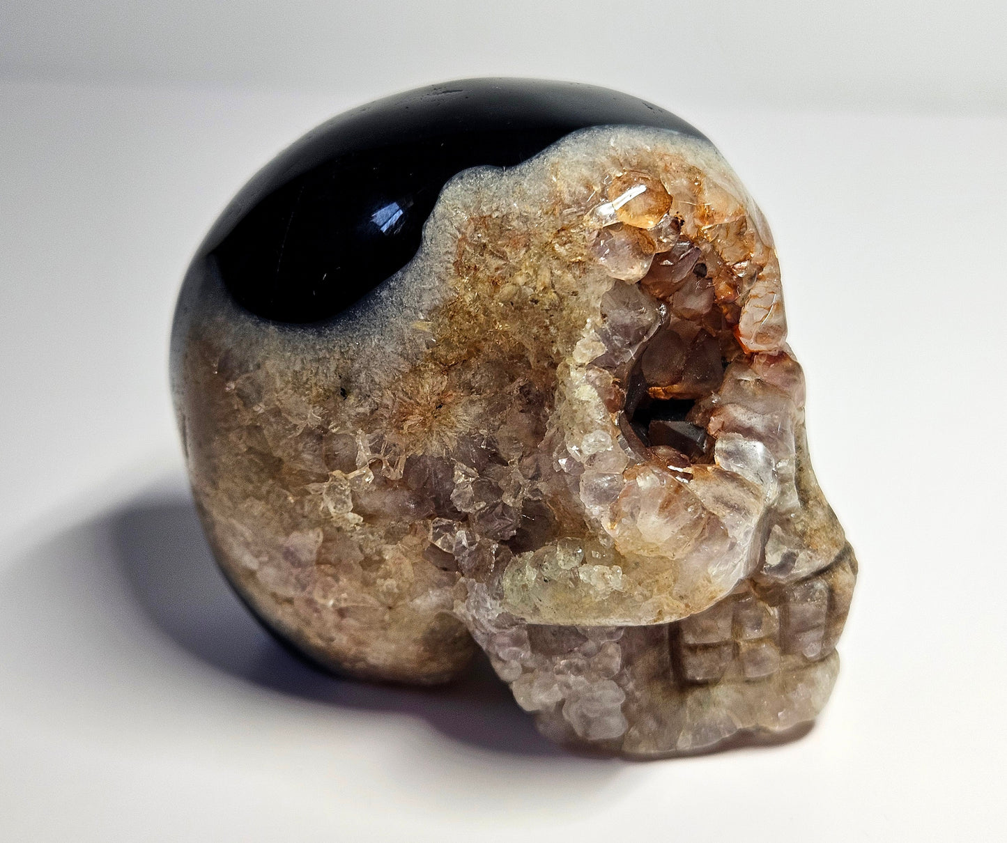 Druzy agate with amethyst and fire quartz skull carving